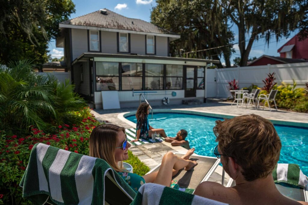 2 couples enjoying pool outside 2 story historic home Airbnb in downtown Lakeland