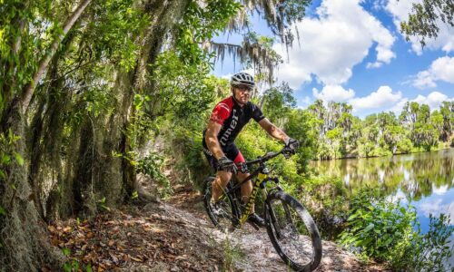cyclist riding Niner bike at Loyce Harpe Park mountain bike trail system in Mulberry, FL